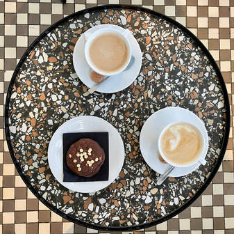 Coffee Break at Mech in the Woods Road bike leaning against the modern Mech cafe nestled in the forest of Las Wolski, Kraków.
